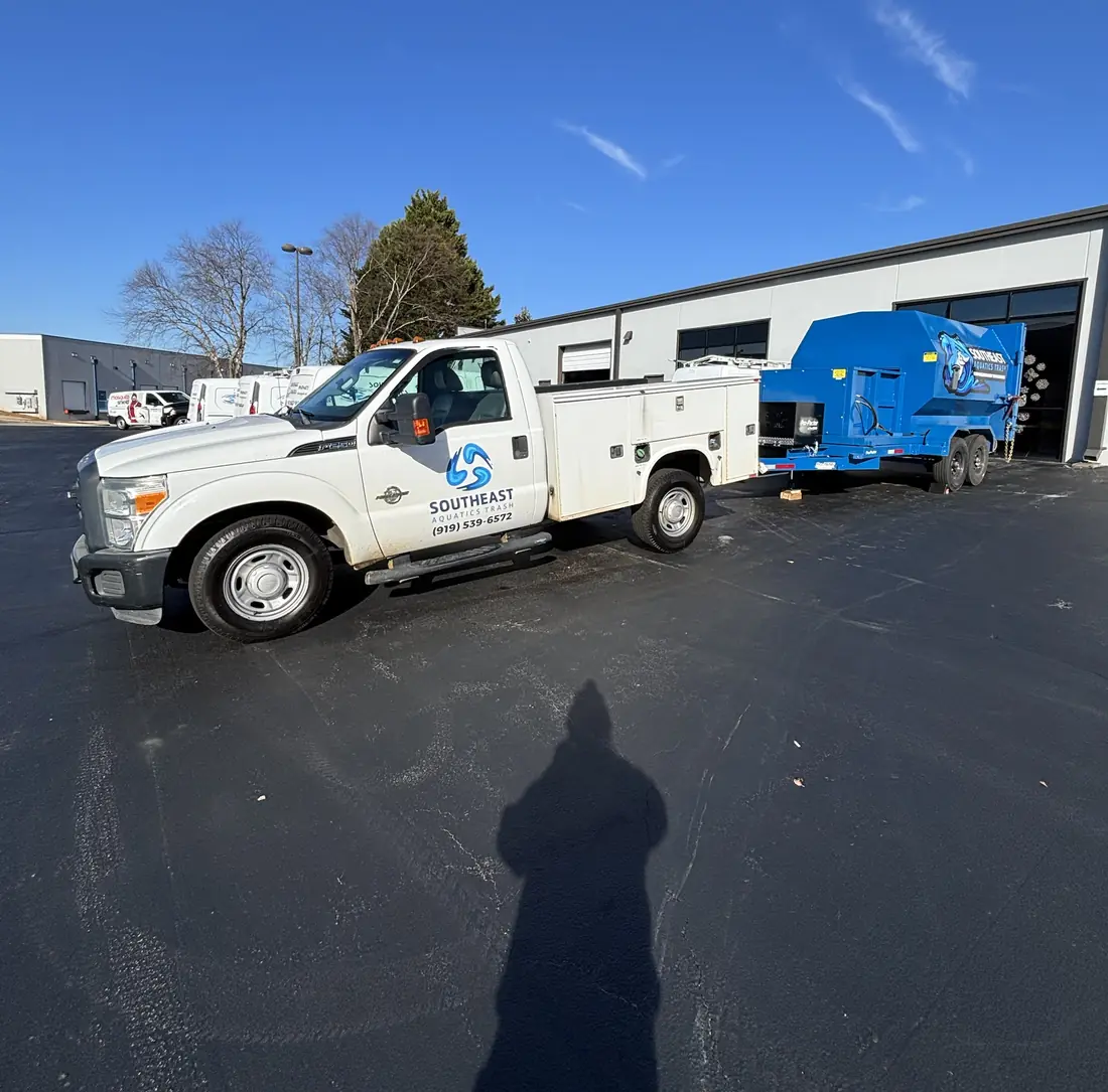 Southeast Aquatics Trash truck and compactor trailer on route